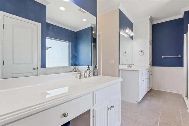 a bathroom with a sink vanity and a mirror