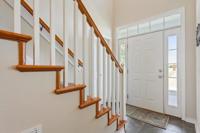 a view of entryway with wooden floor and stairs