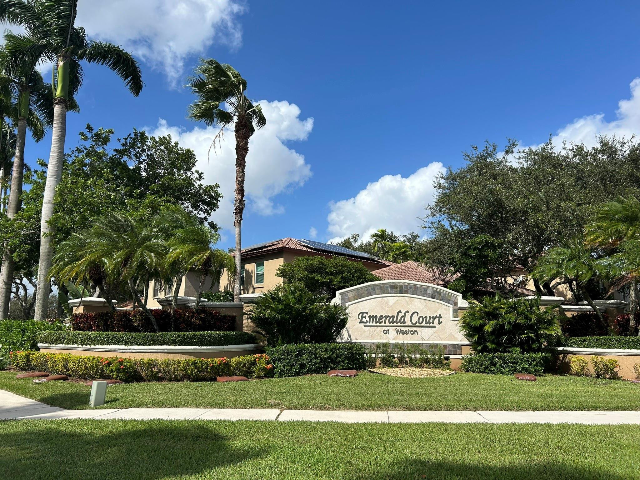 16223 Emerald Cove Road, Unit 16223 Weston, FL 33331 - Photo 1 of 38 a view of a park that has a sign board and trees