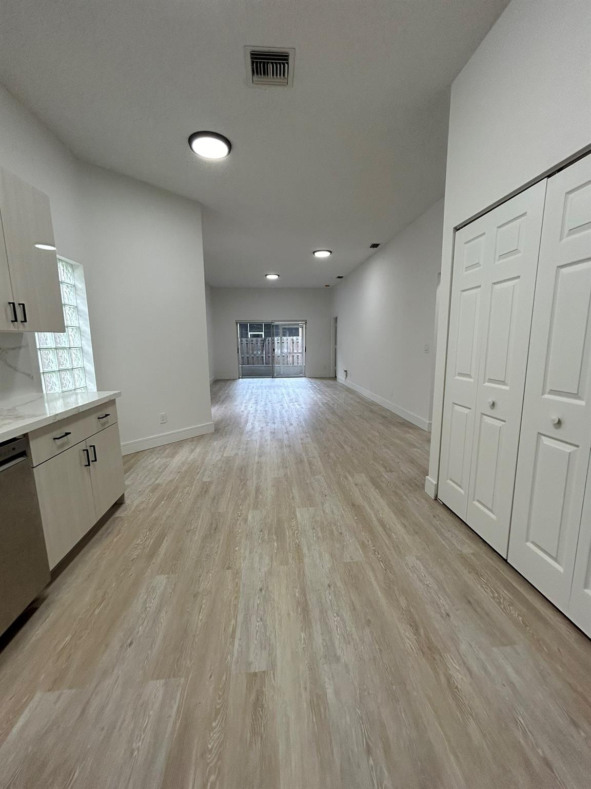 16223 Emerald Cove Road, Unit 16223 Weston, FL 33331 - Photo 12 of 38 an empty room with wooden floor and cabinet