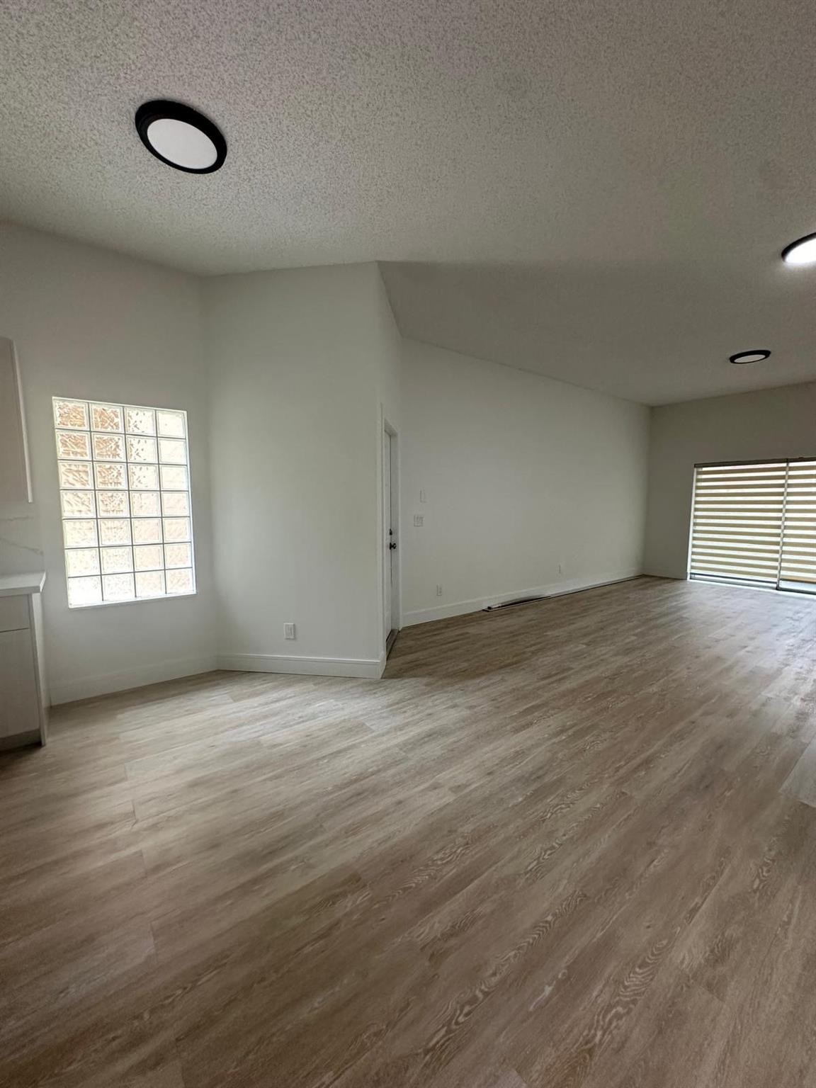16223 Emerald Cove Road, Unit 16223 Weston, FL 33331 - Photo 13 of 38 an empty room with wooden floor and windows