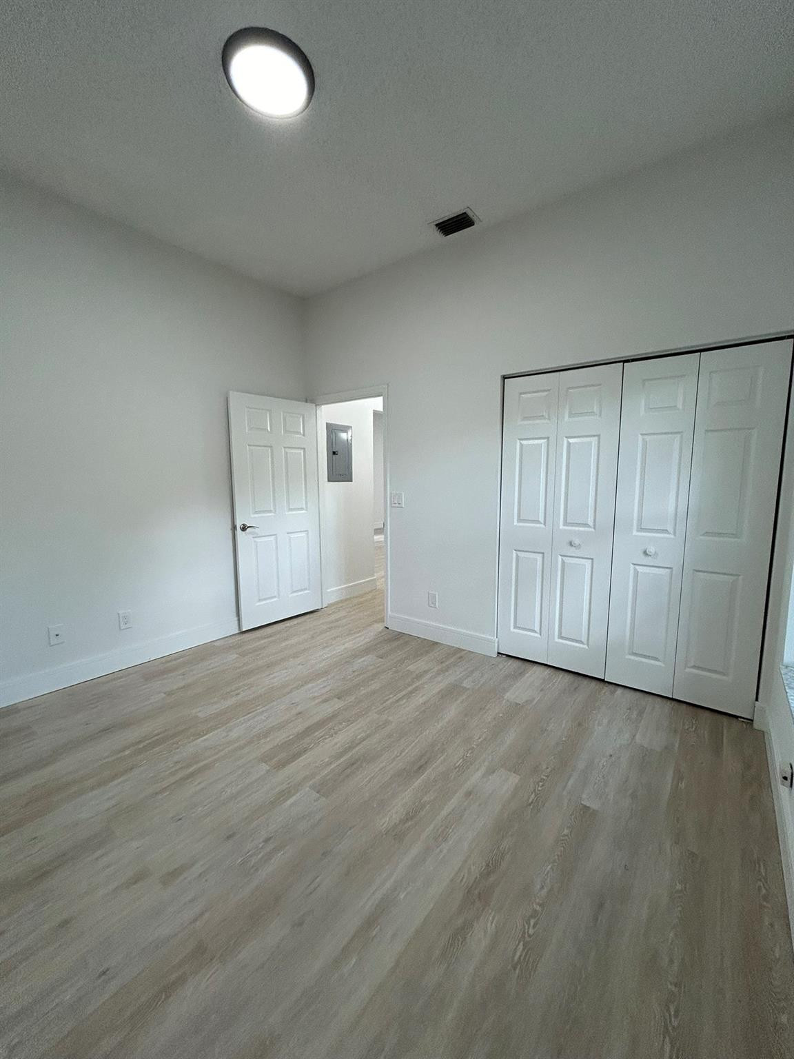 16223 Emerald Cove Road, Unit 16223 Weston, FL 33331 - Photo 20 of 38 an empty room with wooden floor and windows