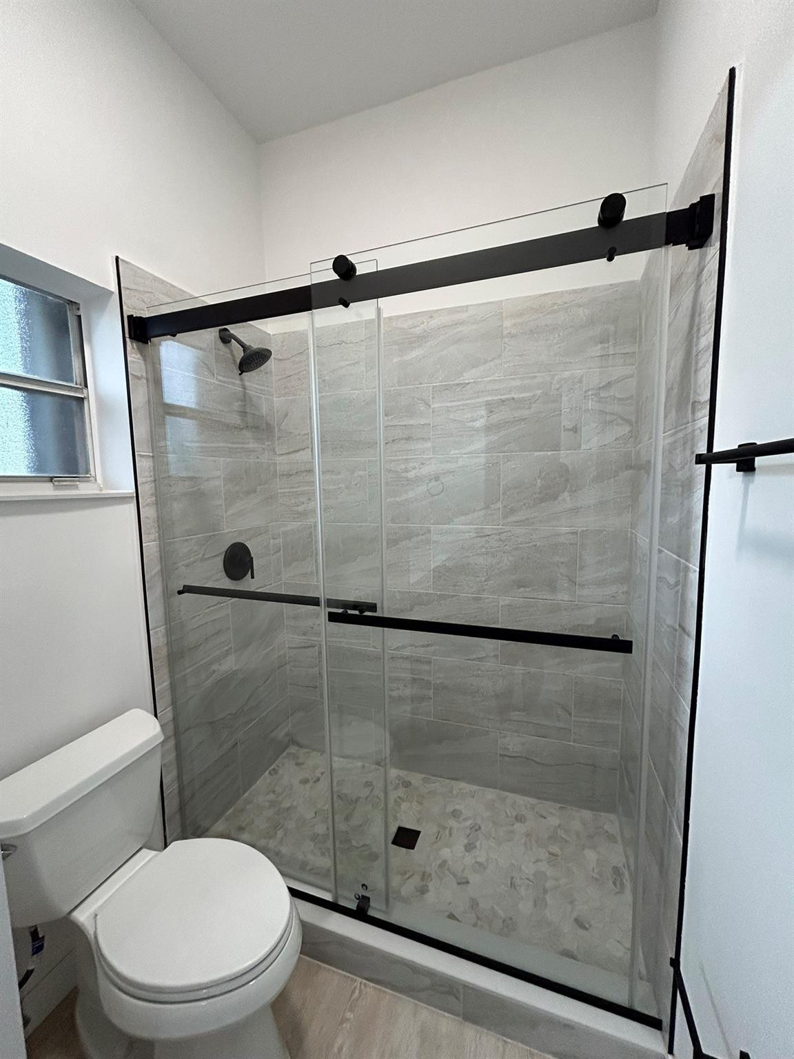 16223 Emerald Cove Road, Unit 16223 Weston, FL 33331 - Photo 29 of 38 a bathroom with a shower and a toilet