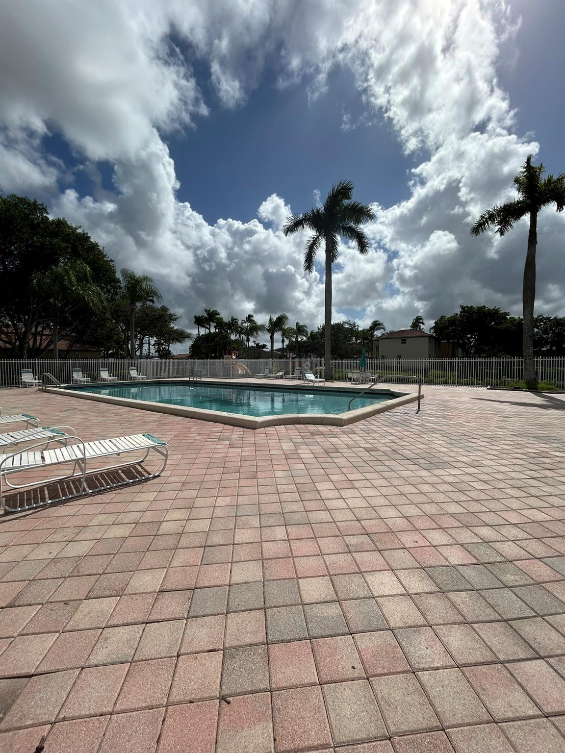 16223 Emerald Cove Road, Unit 16223 Weston, FL 33331 - Photo 33 of 38 a view of a swimming pool and an outdoor seating