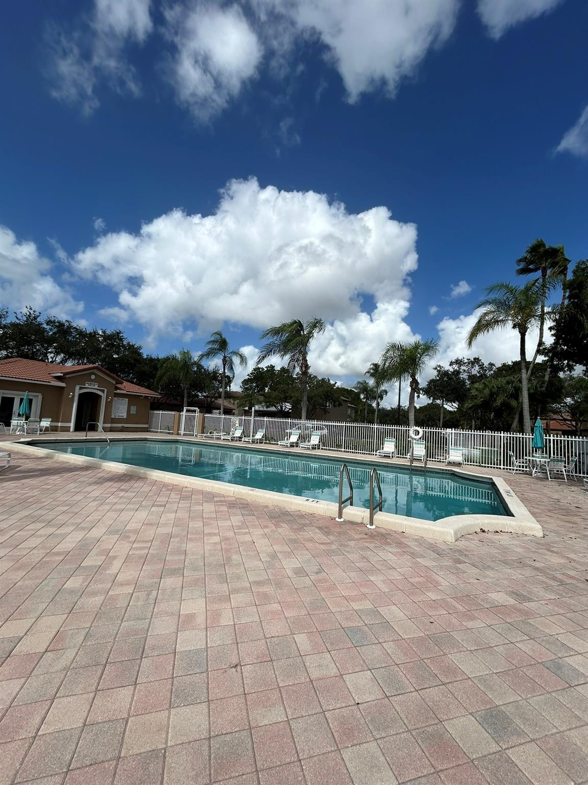 16223 Emerald Cove Road, Unit 16223 Weston, FL 33331 - Photo 34 of 38 a view of backyard with swimming pool and outdoor seating