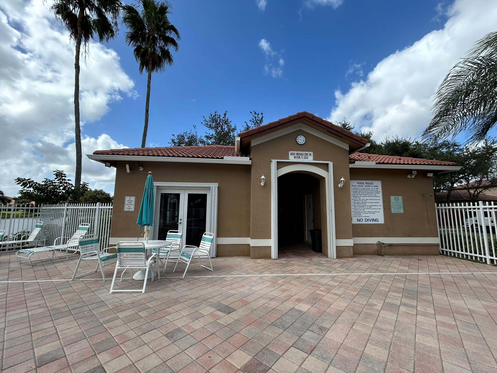 16223 Emerald Cove Road, Unit 16223 Weston, FL 33331 - Photo 35 of 38 a view of a house with a porch and a floor to ceiling window