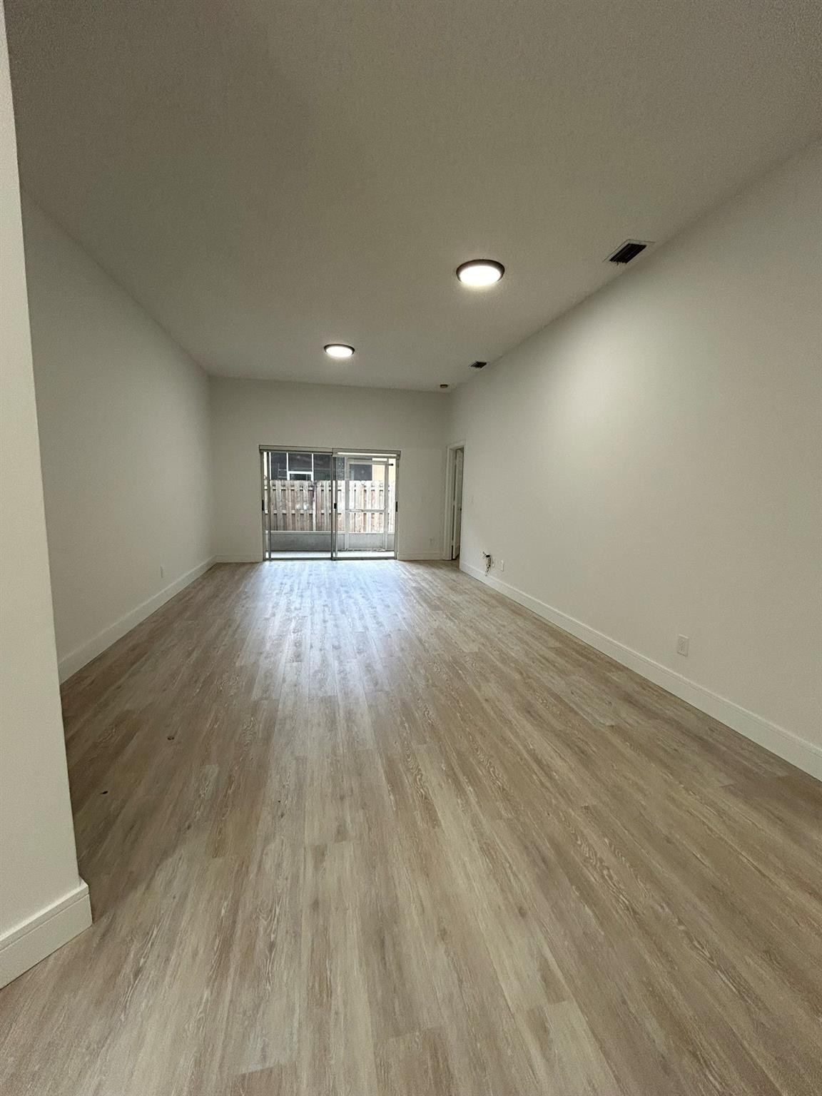 16223 Emerald Cove Road, Unit 16223 Weston, FL 33331 - Photo 7 of 38 an empty room with wooden floor and windows