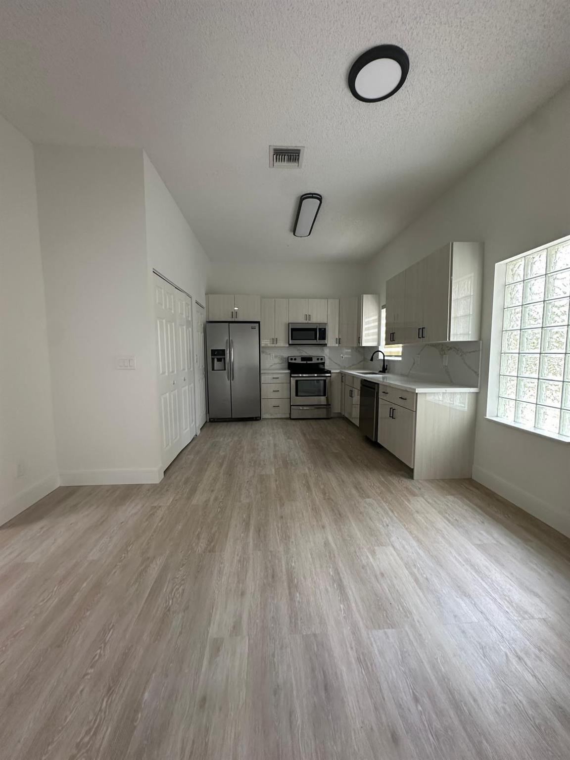 16223 Emerald Cove Road, Unit 16223 Weston, FL 33331 - Photo 9 of 38 a view of a kitchen with furniture and wooden floor