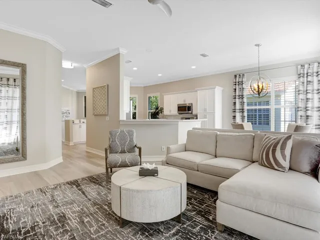 a living room with furniture and kitchen view