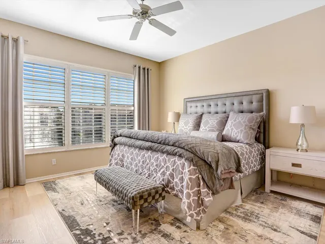 a bedroom with a large bed and a window