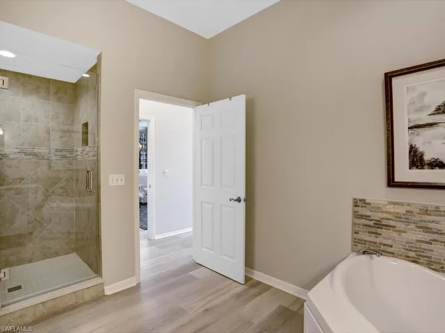 a bathroom with a bathtub and shower