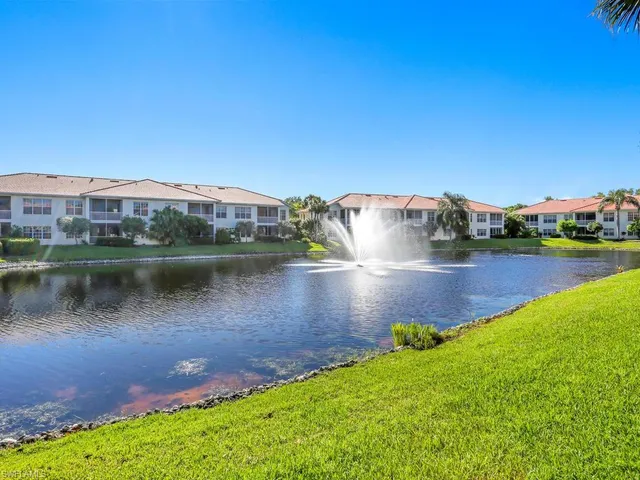 a view of a lake with houses in the back