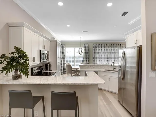 a kitchen with refrigerator and sink