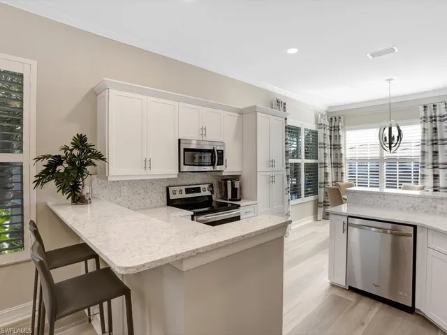 a kitchen with stainless steel appliances a microwave a stove and refrigerator
