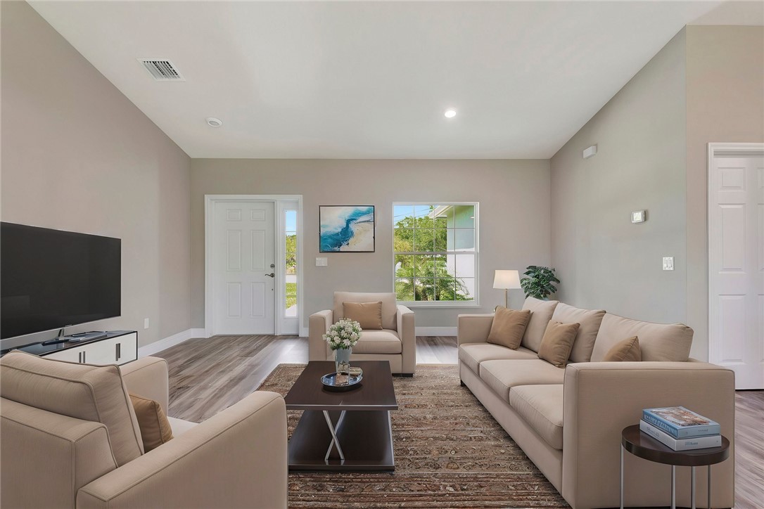 11126 Roseland Road Sebastian, FL 32958 - Photo 2 of 7 a living room with furniture and a flat screen tv