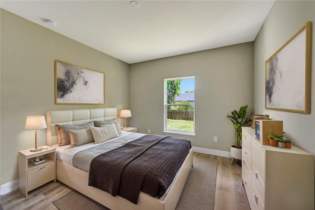 11126 Roseland Road Sebastian, FL 32958 - Photo 7 of 7 a bedroom with a large bed and a window