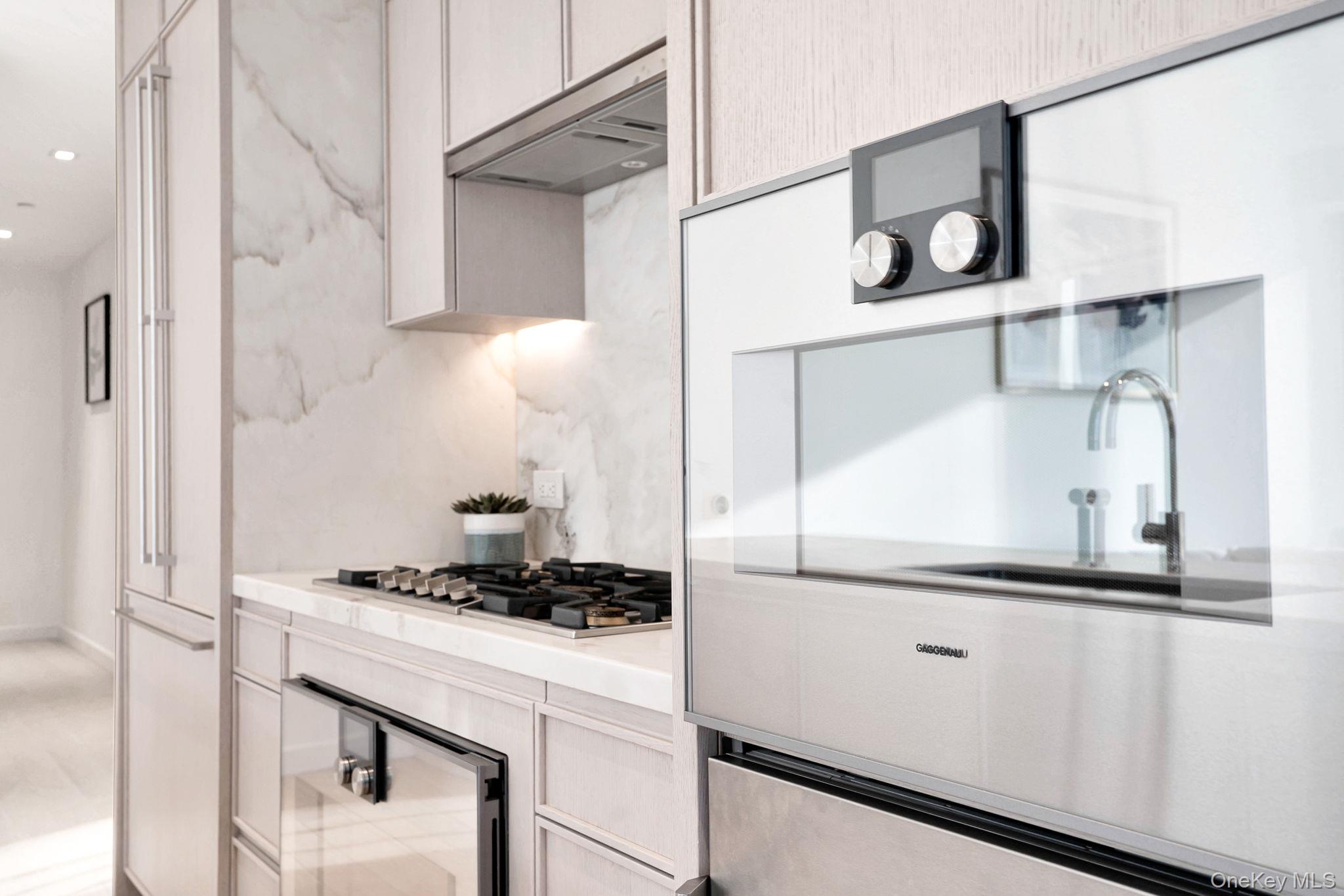 138 East 50th Street, Unit 26C Manhattan, NY 10022 - Photo 14 of 31 a kitchen with a refrigerator and a stove