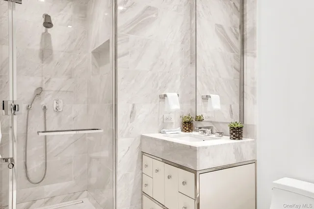 a bathroom with a sink vanity and tub