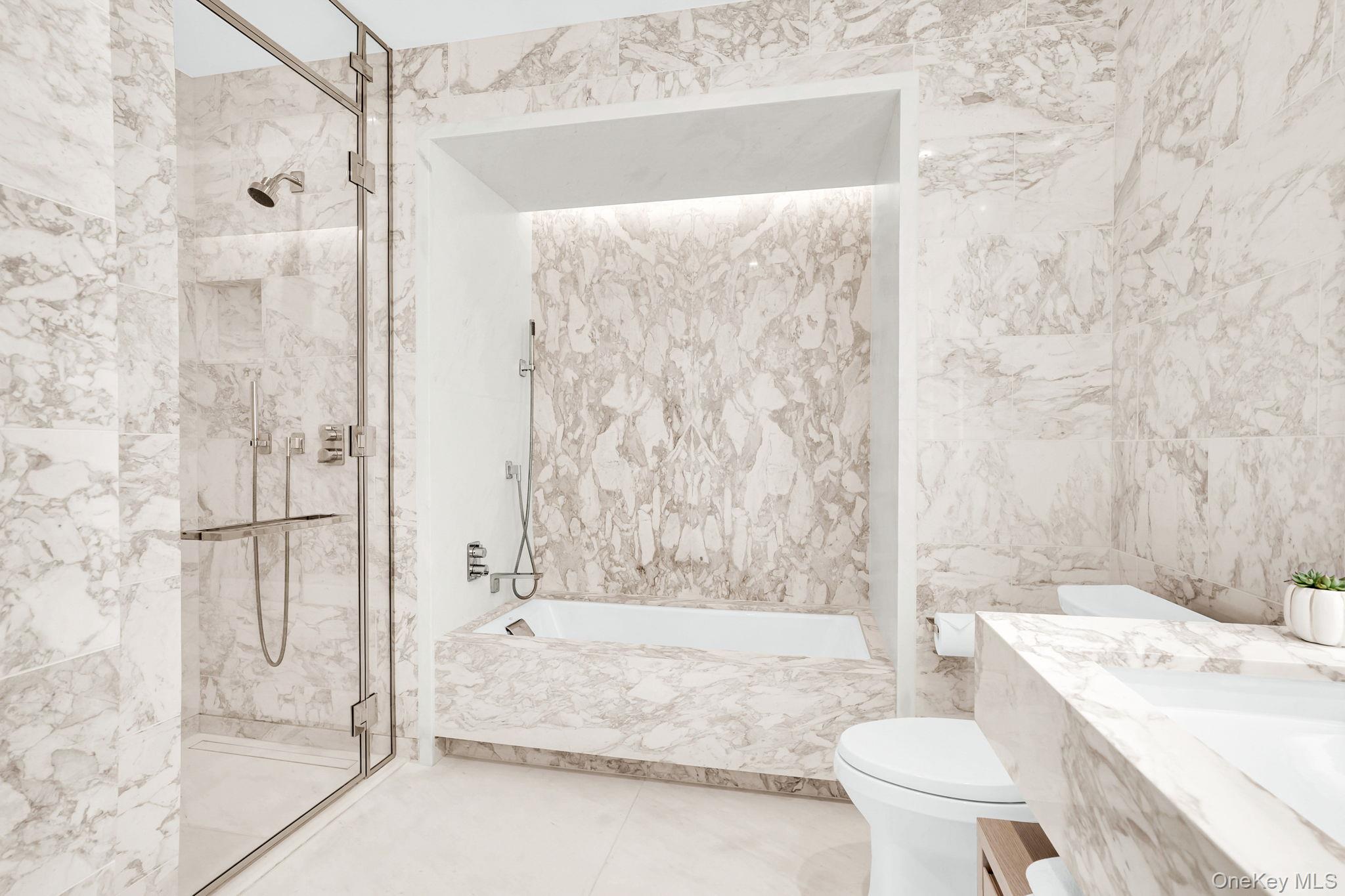 138 East 50th Street, Unit 26C Manhattan, NY 10022 - Photo 21 of 31 a bathroom with a granite countertop bathtub shower sink and toilet