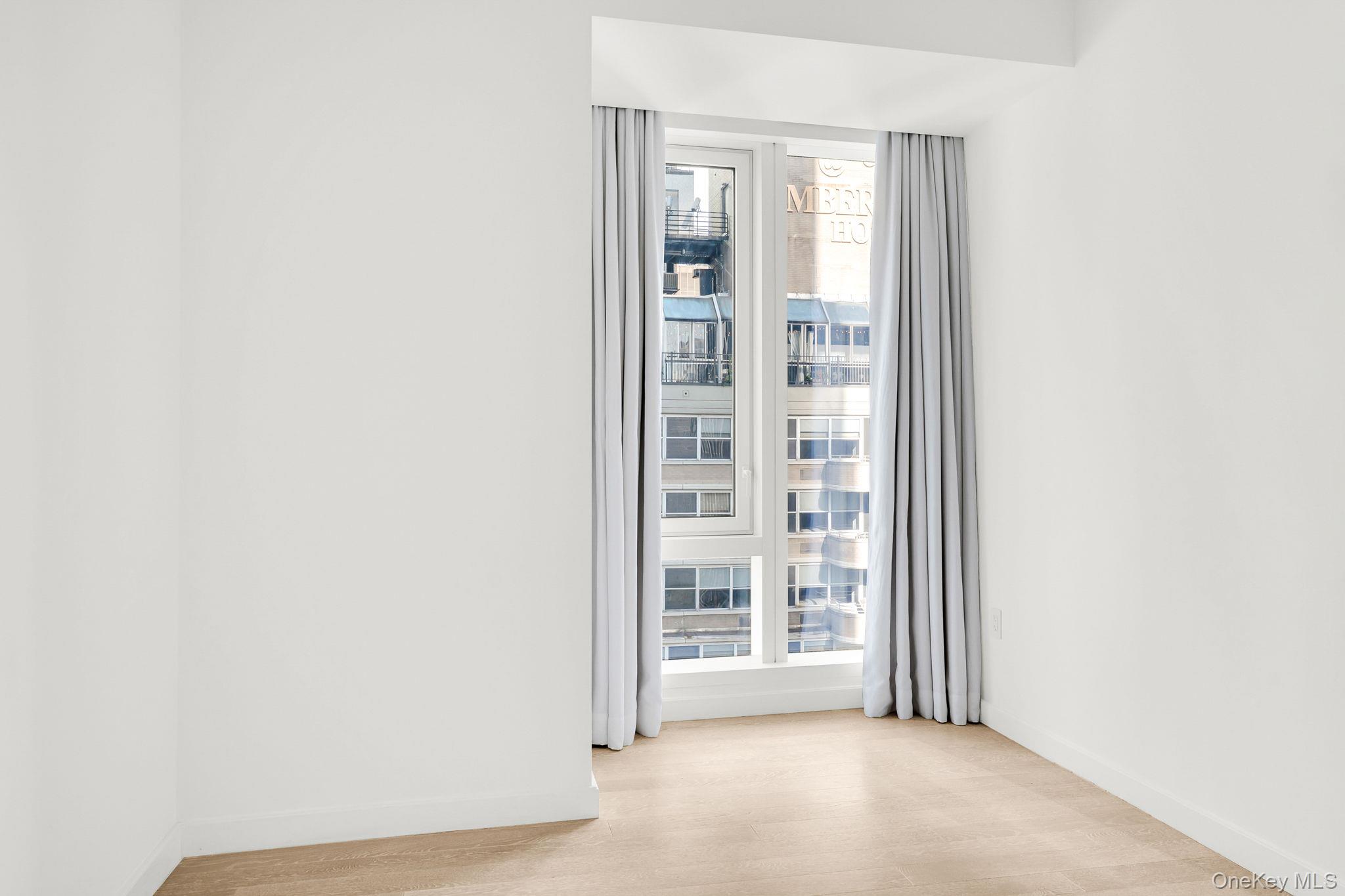 138 East 50th Street, Unit 26C Manhattan, NY 10022 - Photo 24 of 31 a view of an empty room with a window