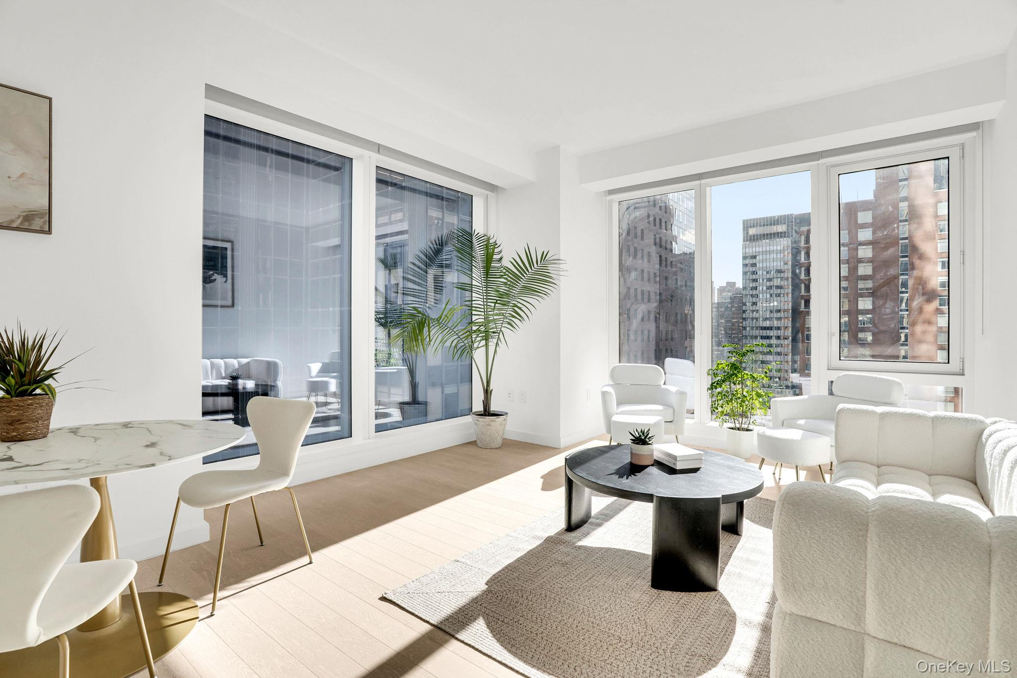 138 East 50th Street, Unit 26C Manhattan, NY 10022 - Photo 4 of 31 a living room with furniture and a large window