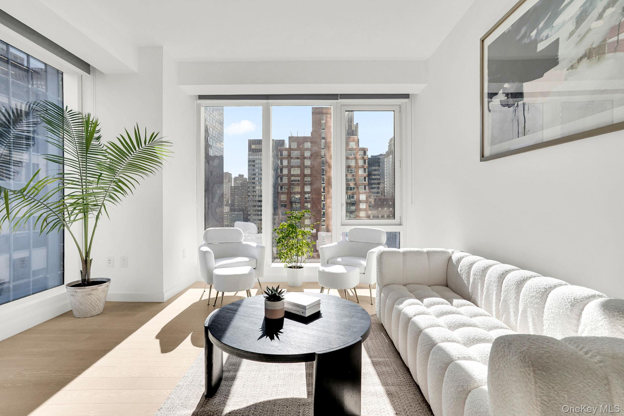 138 East 50th Street, Unit 26C Manhattan, NY 10022 - Photo 5 of 31 a living room with furniture and a potted plant