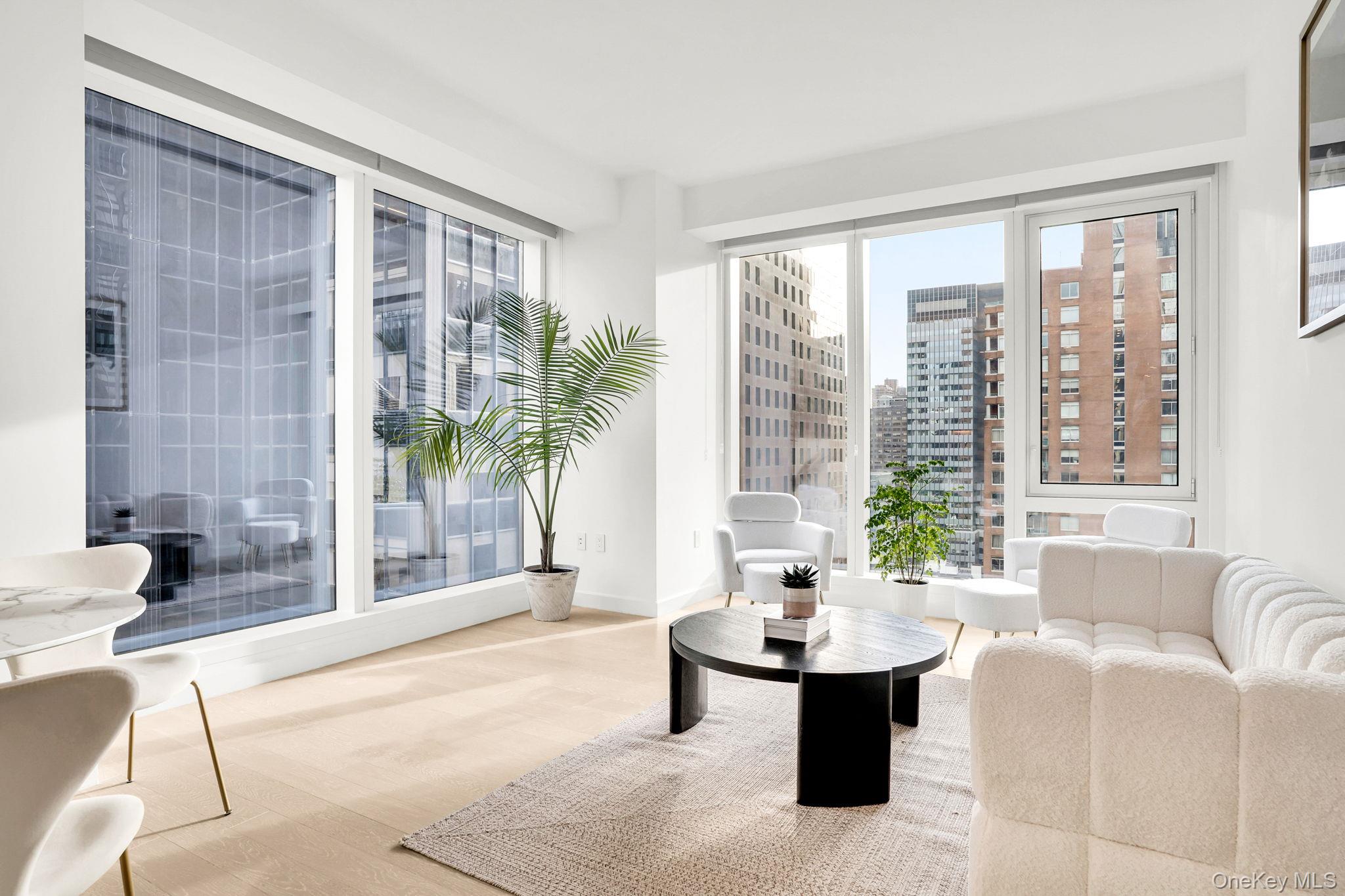 138 East 50th Street, Unit 26C Manhattan, NY 10022 - Photo 6 of 31 a living room with furniture and large windows