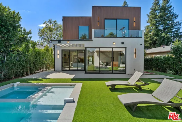 a view of house with swimming pool outdoor seating and yard