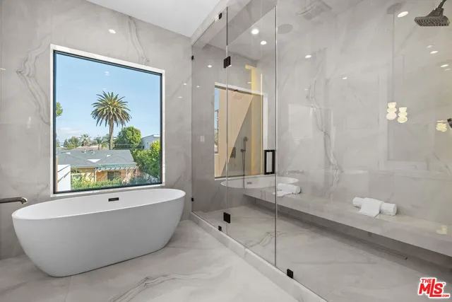 a white bath tub sitting next to a shower