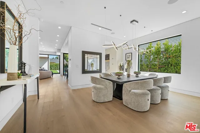 a living room with large window and furniture