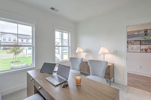 a dining room with furniture and wooden floor