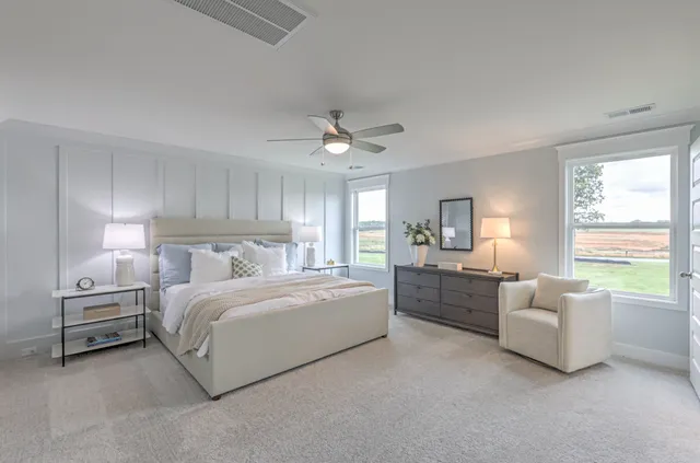 a kitchen with stainless steel appliances granite countertop a stove a refrigerator a kitchen island a table and chairs