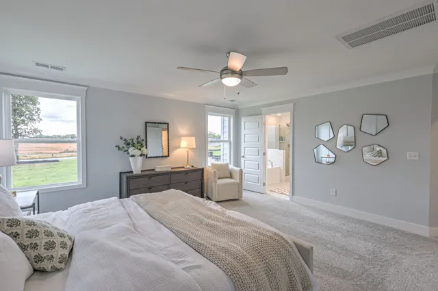 a kitchen with stainless steel appliances kitchen island granite countertop a dining table chairs refrigerator and sink