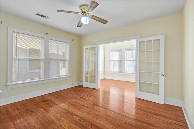 a view of empty room with wooden floor