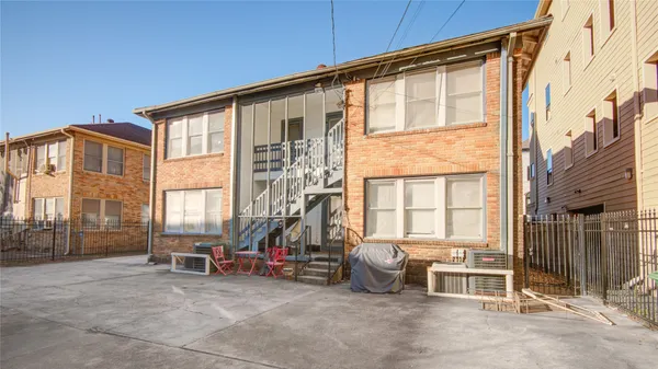a view of a blue house with a street