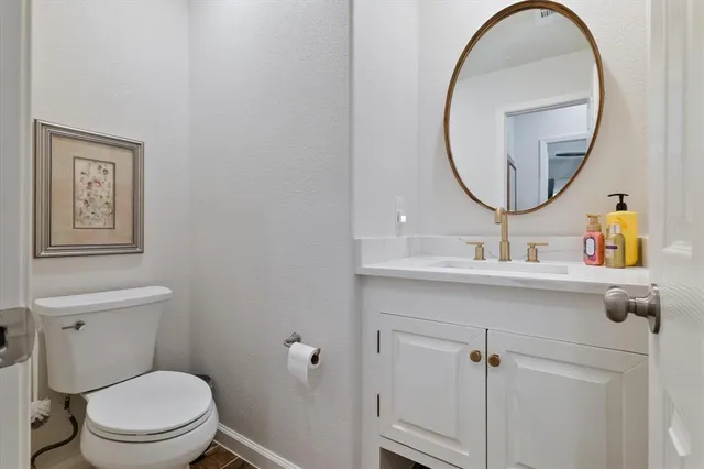 a bathroom with a toilet a sink and a mirror