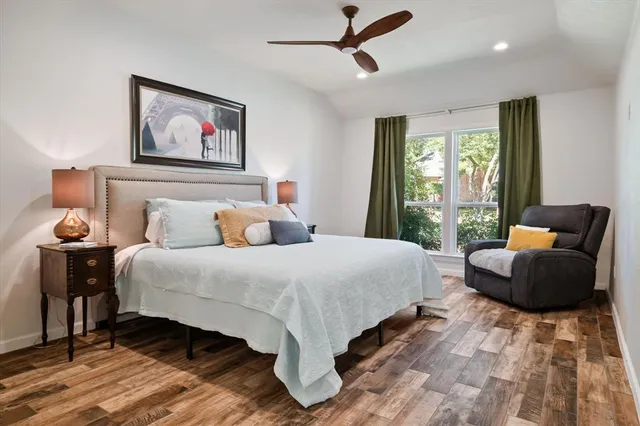 a bedroom with bed and wooden floor