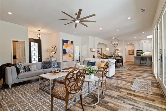 a living room with furniture and a view of kitchen