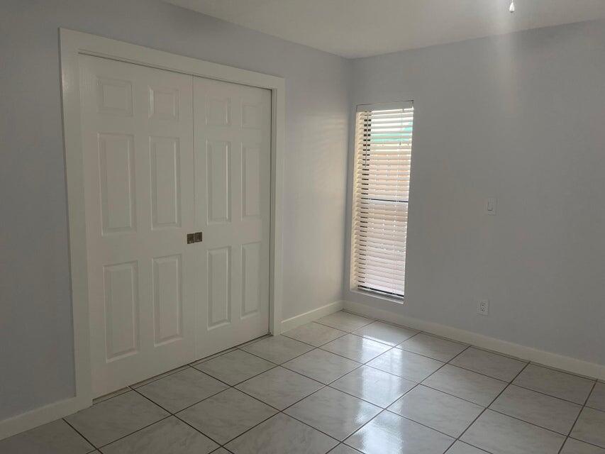 639 Executive Center Drive, Unit O107 West Palm Beach, FL 33401 - Photo 12 of 21 a view of an empty room with a window