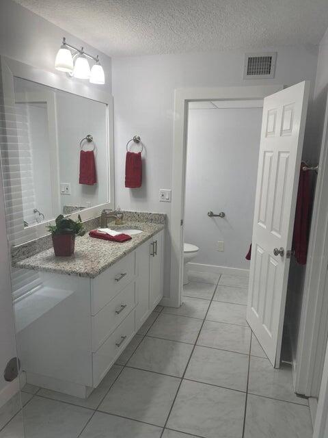 639 Executive Center Drive, Unit O107 West Palm Beach, FL 33401 - Photo 15 of 21 a bathroom with a sink and a mirror