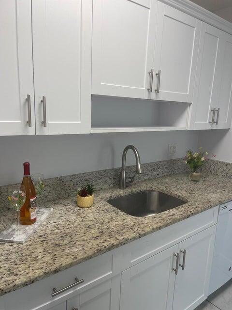 639 Executive Center Drive, Unit O107 West Palm Beach, FL 33401 - Photo 10 of 21 a kitchen with a sink and cabinets