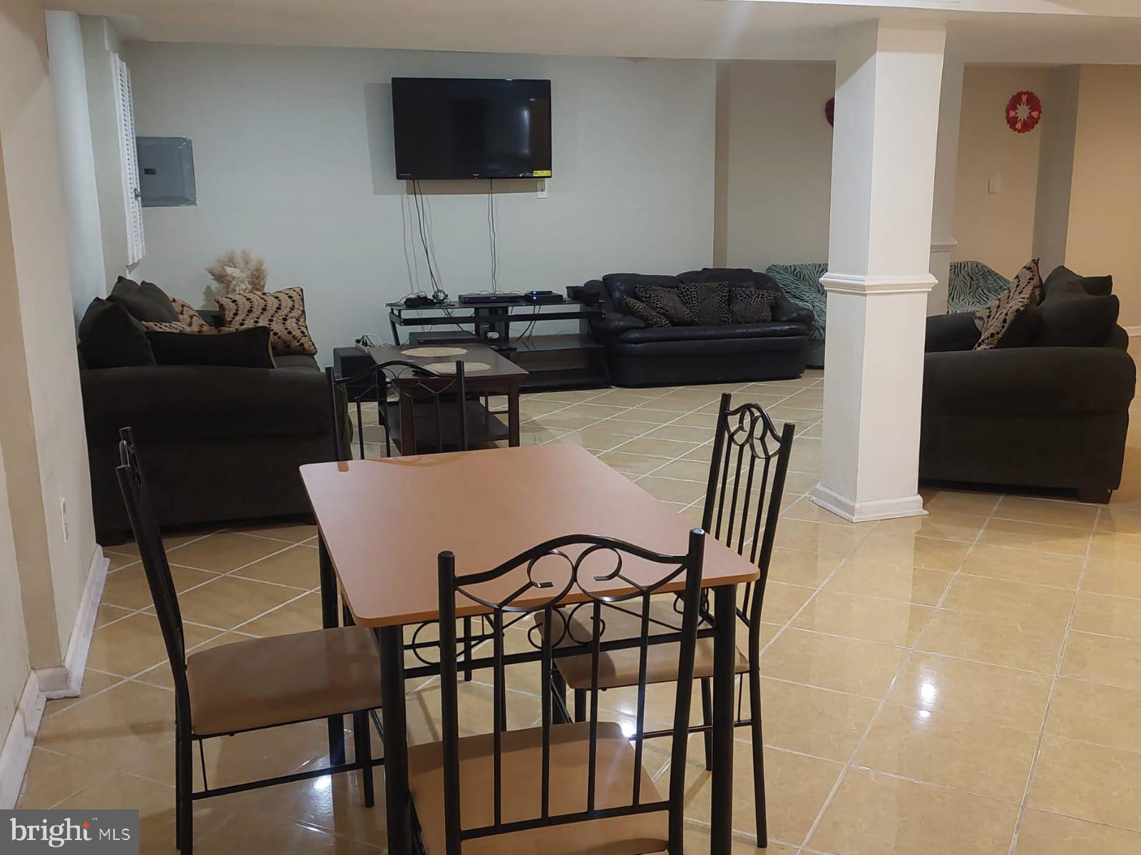 14606 Dewey Ridge Court Bowie, MD 20721 - Photo 2 of 11 a living room with furniture and a flat screen tv