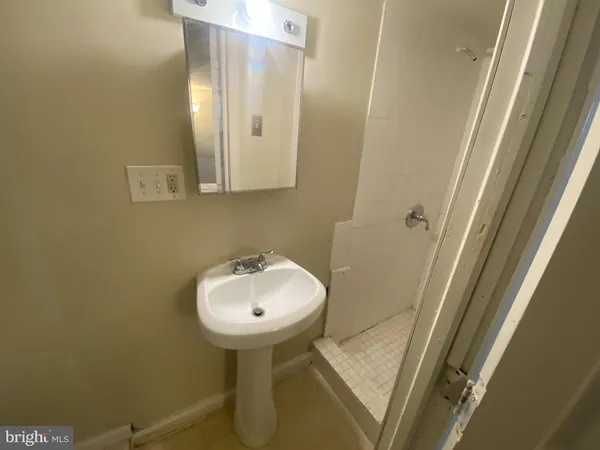 a bathroom with a sink and mirror