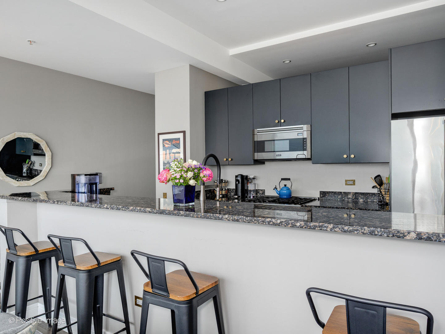 500 West Superior Street, Unit 1202 Chicago, IL 60654 - Photo 10 of 29 a kitchen with stainless steel appliances granite countertop a dining table and chairs
