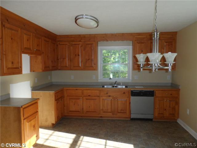 4166 Wakema Road West Point, VA 23181 - Photo 4 of 10 a kitchen with stainless steel appliances granite countertop a sink and a stove