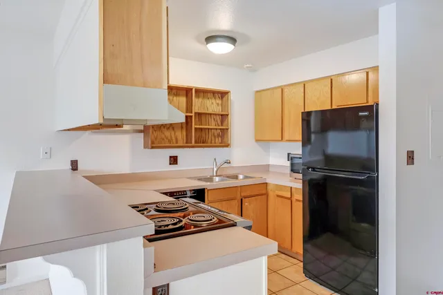a kitchen with a stove a sink and a refrigerator