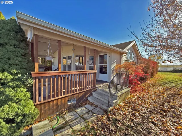 a living room with furniture fireplace and a large window