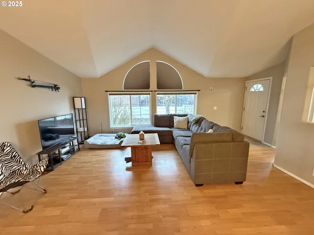 a living room with furniture and wooden floor