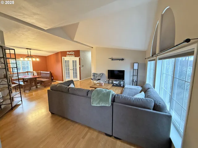 a living room with furniture and a piano