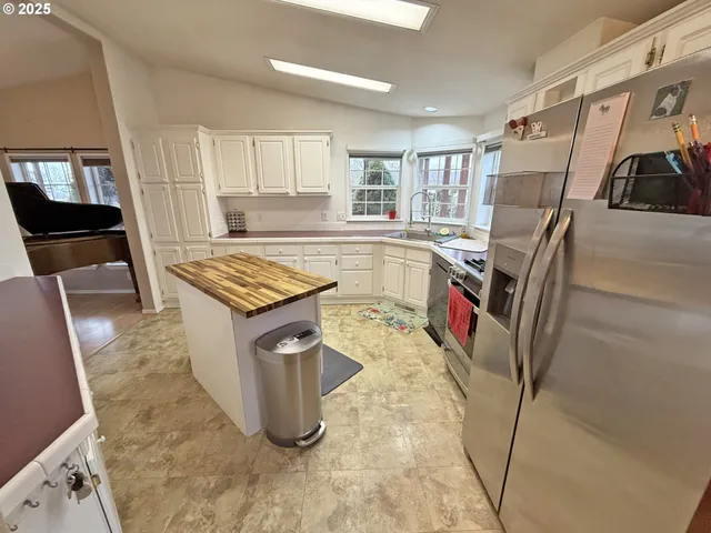 a kitchen with stainless steel appliances granite countertop a stove and cabinets